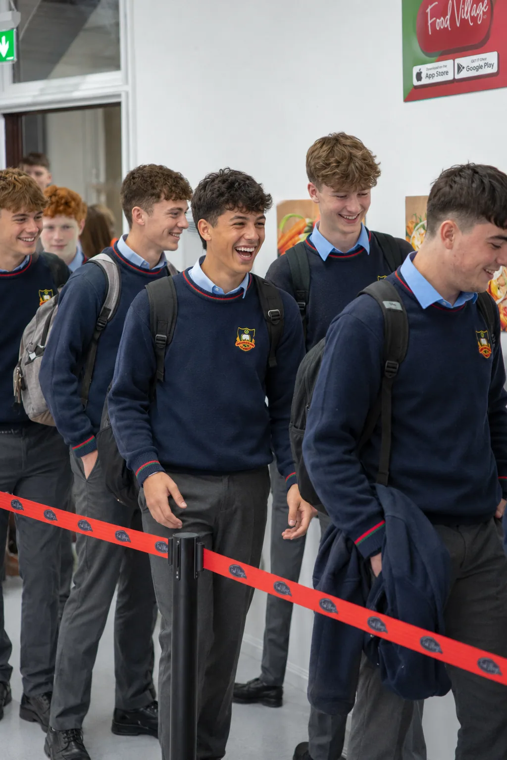 Students laughing while queuing to collect their Food Village order